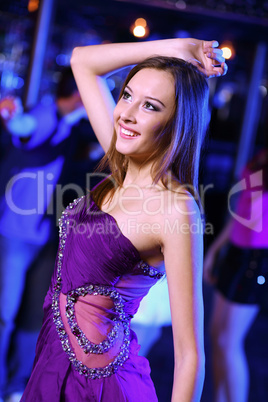 Young woman having fun at nightclub disco