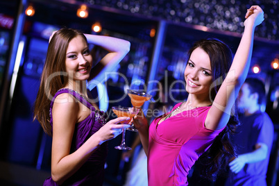 Young woman having fun at nightclub disco