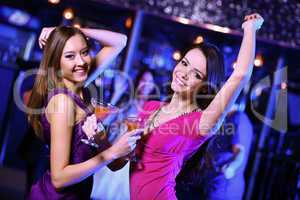 Young woman having fun at nightclub disco