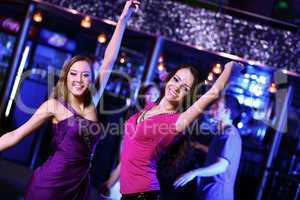 Young woman having fun at nightclub disco