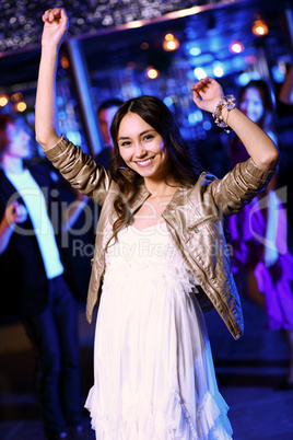 Young woman having fun at nightclub disco