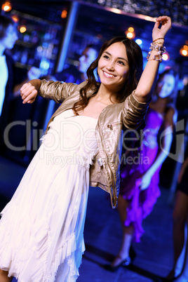 Young woman having fun at nightclub disco