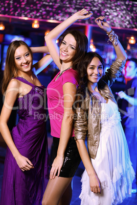 Young woman having fun at nightclub disco