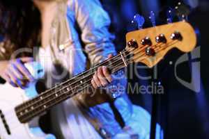 Young guitar player performing in night club