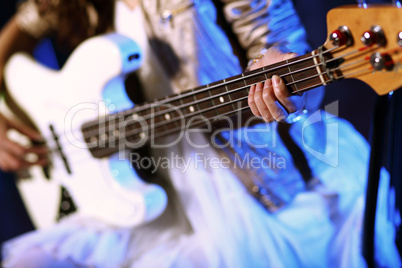 Young guitar player performing in night club