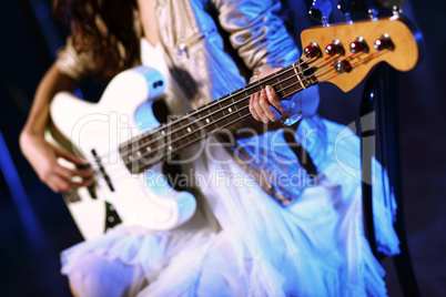 Young guitar player performing in night club