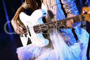 Young guitar player performing in night club