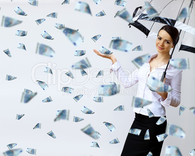 Business woman under money rain with umbrella