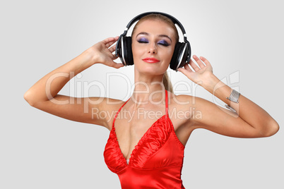 Young woman in evening dress with headphones