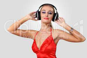 Young woman in evening dress with headphones