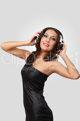 Young woman in evening dress with headphones