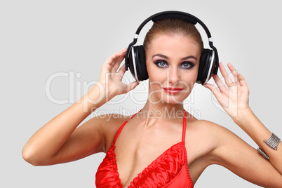 Young woman in evening dress with headphones