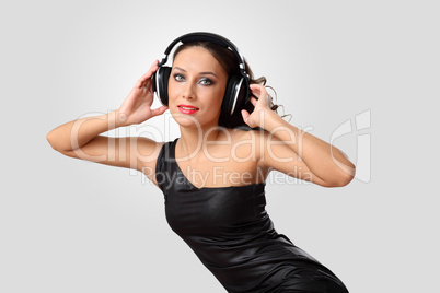 Young woman in evening dress with headphones