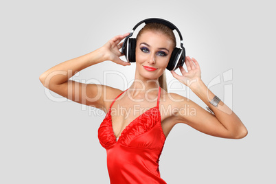 Young woman in evening dress with headphones