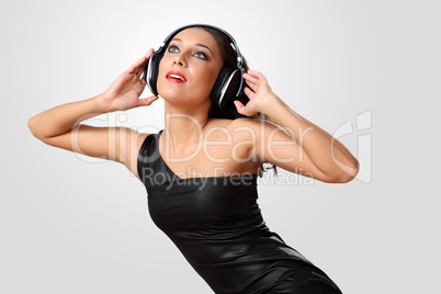 Young woman in evening dress with headphones