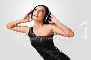 Young woman in evening dress with headphones
