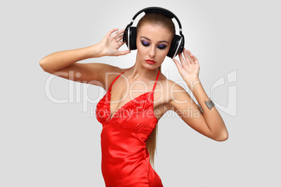 Young woman in evening dress with headphones