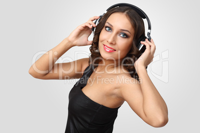 Young woman in evening dress with headphones