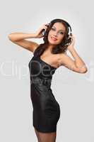 Young woman in evening dress with headphones