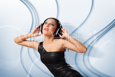 Young woman in evening dress with headphones