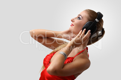 Young woman in evening dress with headphones