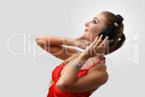 Young woman in evening dress with headphones