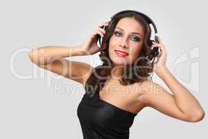 Young woman in evening dress with headphones