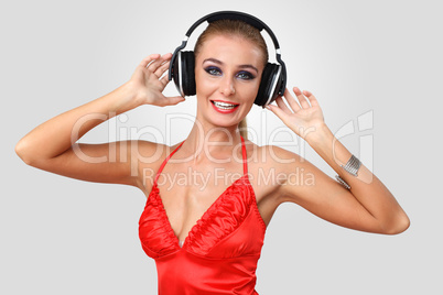 Young woman in evening dress with headphones