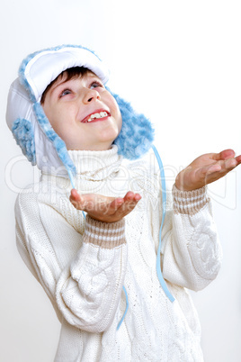 Kid in winter wear against white background