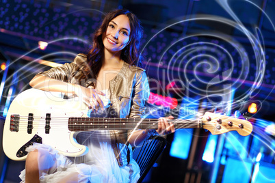 Young guitar player performing in night club