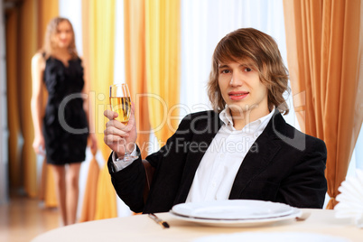 Young handsome man sitting in restaurant