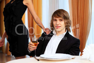 Young handsome man sitting in restaurant