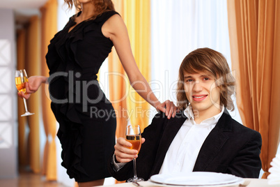 Young handsome man sitting in restaurant