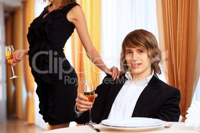 Young handsome man sitting in restaurant