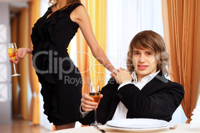 Young handsome man sitting in restaurant