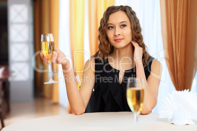 Young pretty woman sitting in restaurant