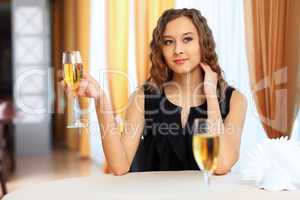 Young pretty woman sitting in restaurant