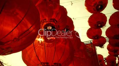 Red lanterns tassel swaying in wind,behind sun,elements of East,china new year.