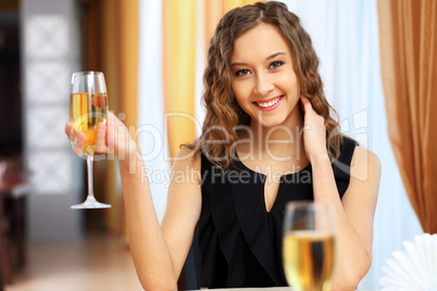 Young pretty woman sitting in restaurant