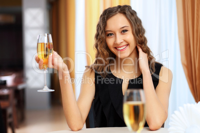 Young pretty woman sitting in restaurant