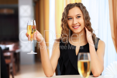 Young pretty woman sitting in restaurant