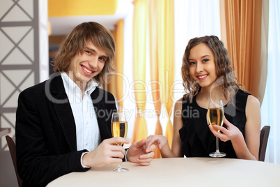 Couple in a restaurant with shampagne