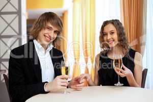 Couple in a restaurant with shampagne