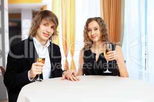 Couple in a restaurant with shampagne