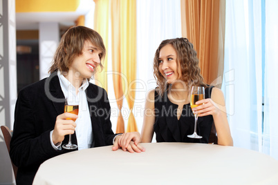 Couple in a restaurant with shampagne