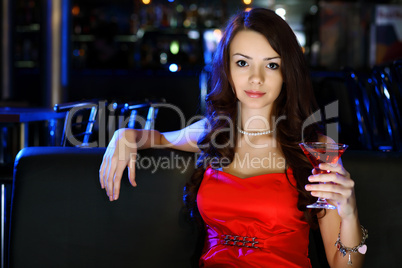 Attractive woman in night club with a drink