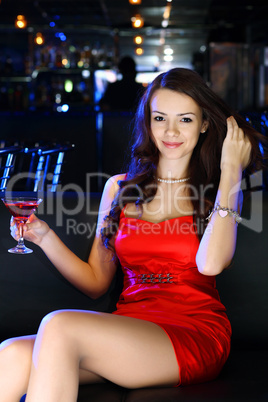 Attractive woman in night club with a drink