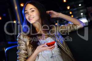 Attractive woman in night club with a drink