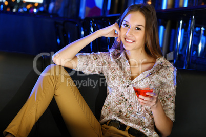 Attractive woman in night club with a drink