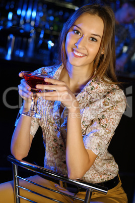 Attractive woman in night club with a drink